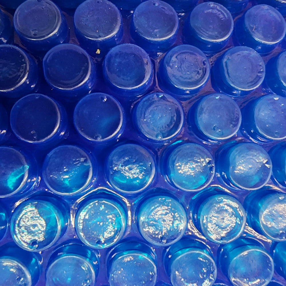 Close-up of Aqua-Guard 12 Mil solar blanket texture in blue, designed for enhanced heat retention and reduced evaporation.